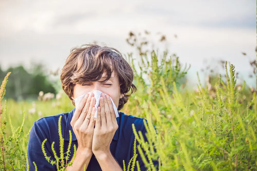 woman blowing nose.