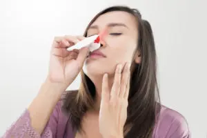 Woman with nosebleed