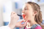 Child getting throat examined.