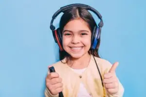 Girl wearing special headphones getting hearing test