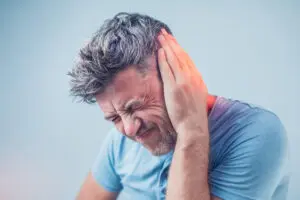 Man holding his ear in pain.