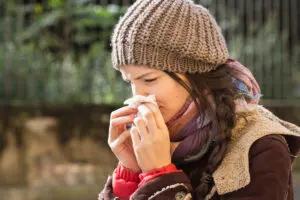 Woman suffering from winter allergies. 